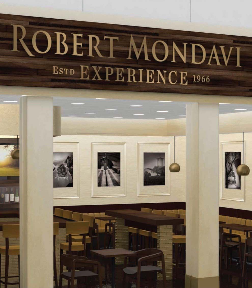 3D rendering of the Robert Mondavi Experience, showing tables and chairs set up in a bright room with winemaking-themed art on the walls.